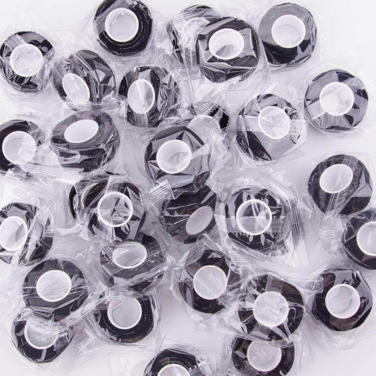 Collection of individually wrapped black adhesive strips for skin care, designed for comfort and easy application.
