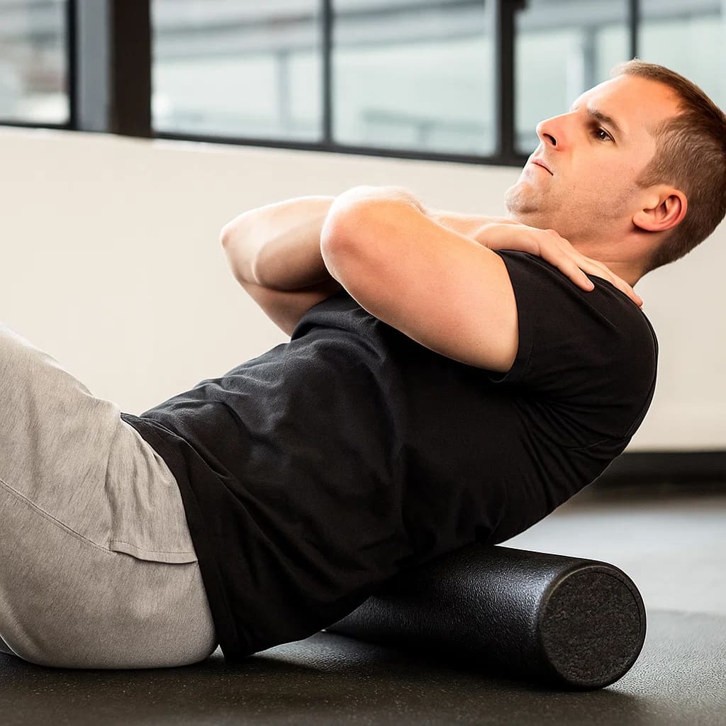Man performing muscle recovery exercises with MobiloRoll foam roller for tension relief and enhanced mobility.